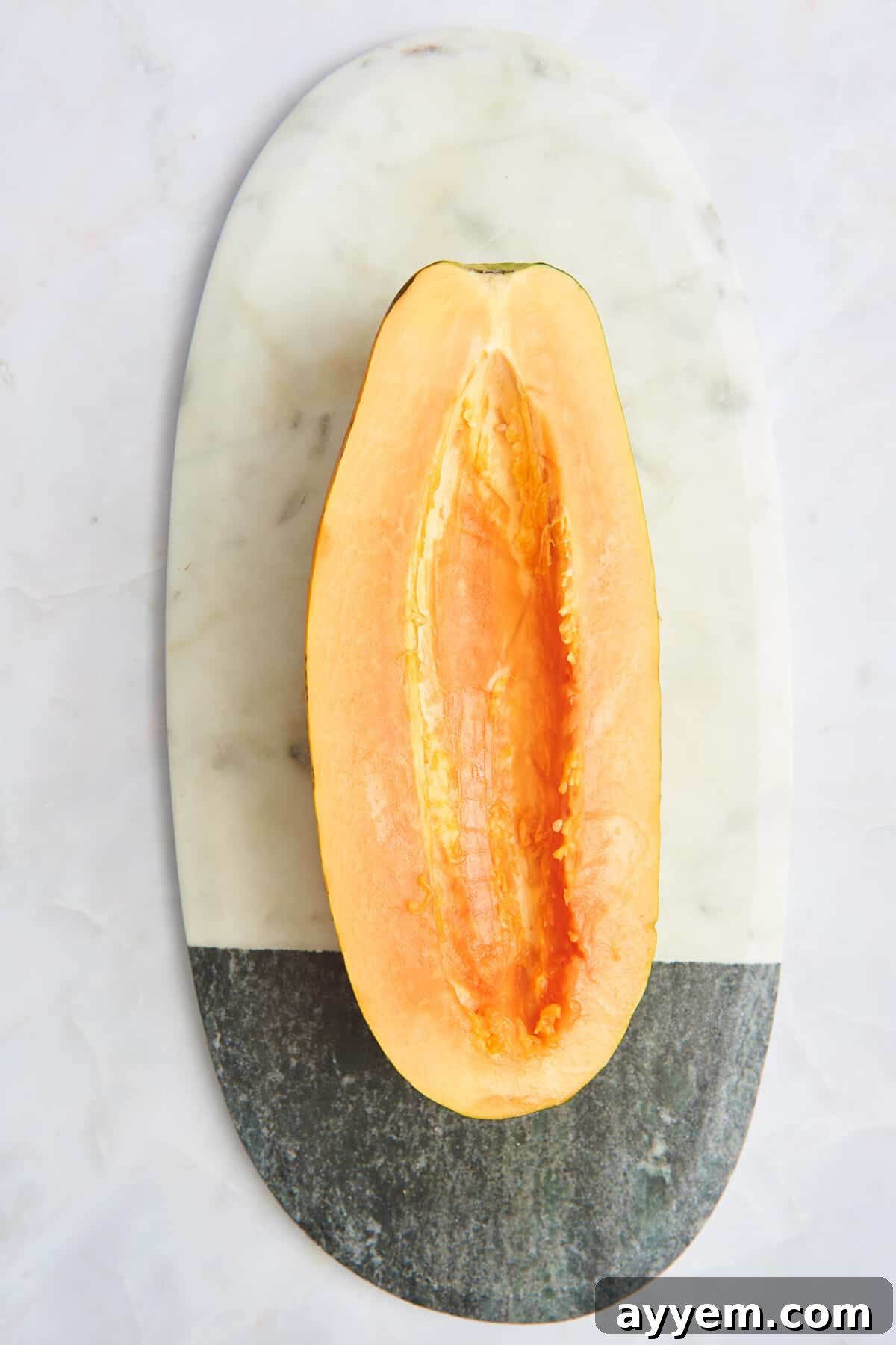 Half a papaya with the seeds removed.