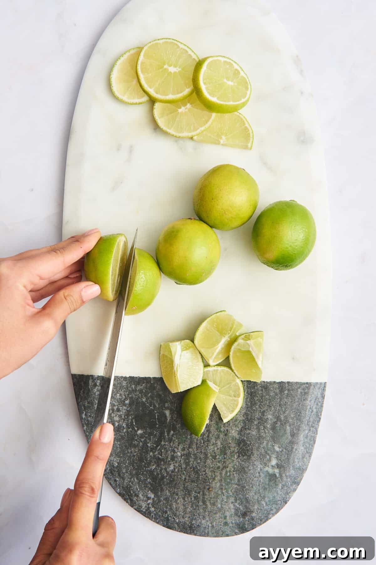 Lime rounds, whole limes, lime wedges, and a lime being halved on a cutting board, showcasing various cuts and forms of the citrus fruit.
