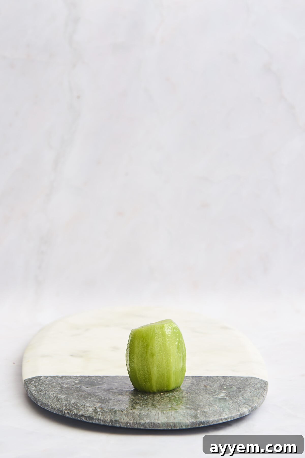 Slice Your Kiwi Like a Pro 6 A peeled kiwi on a cutting board, ready for various slicing techniques.