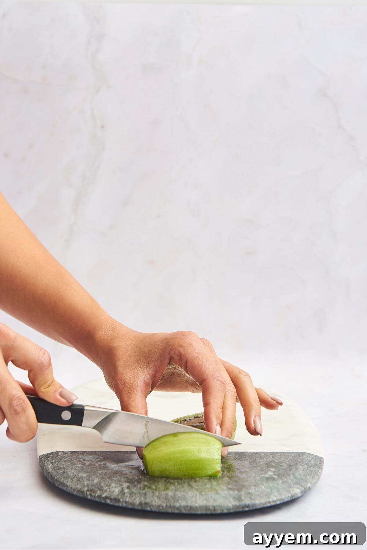Slice Your Kiwi Like a Pro 8 Hands cutting a skinless kiwi half into wedges, illustrating the quartering technique.