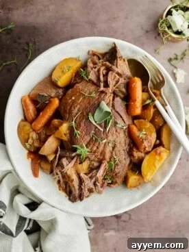 A hearty slow cooker beef pot roast with tender vegetables and rich gravy.