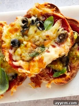 Slices of freshly baked sheet pan pizza on a plate, topped with melted cheese and pepperoni.