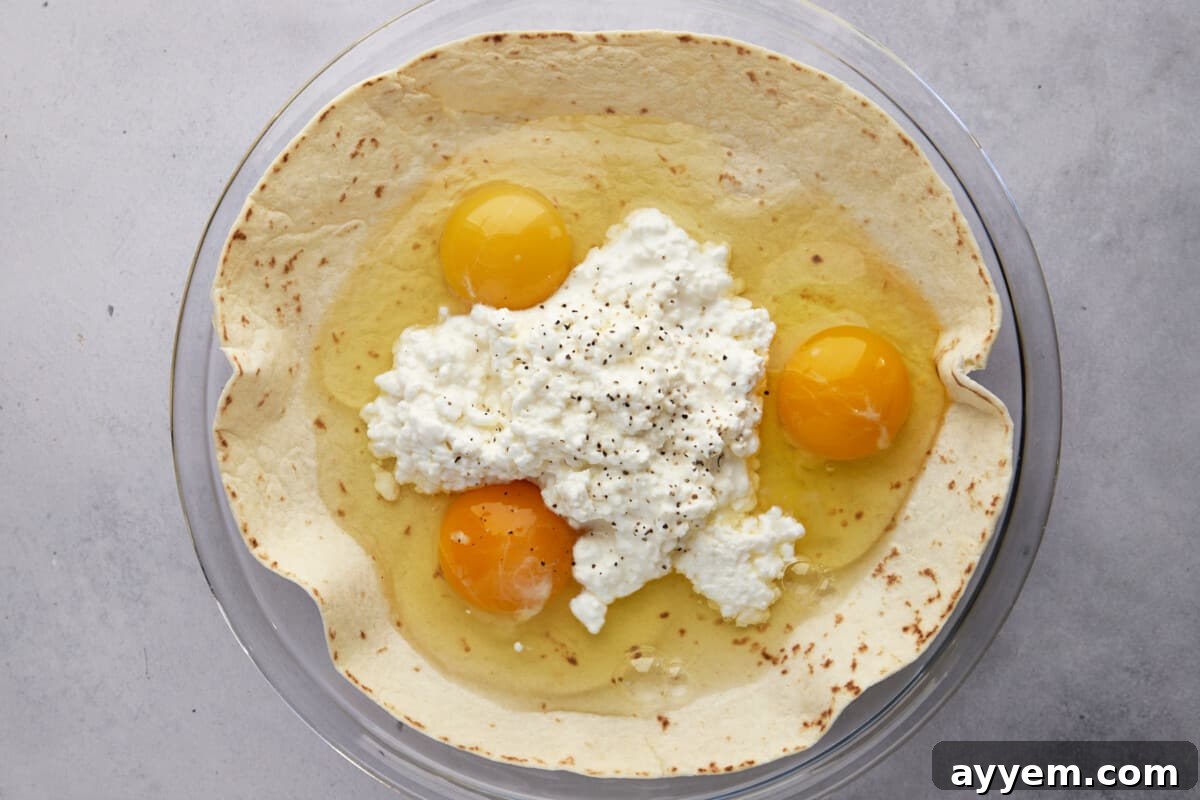 Three eggs and cottage cheese over a large tortilla in a round dish. 