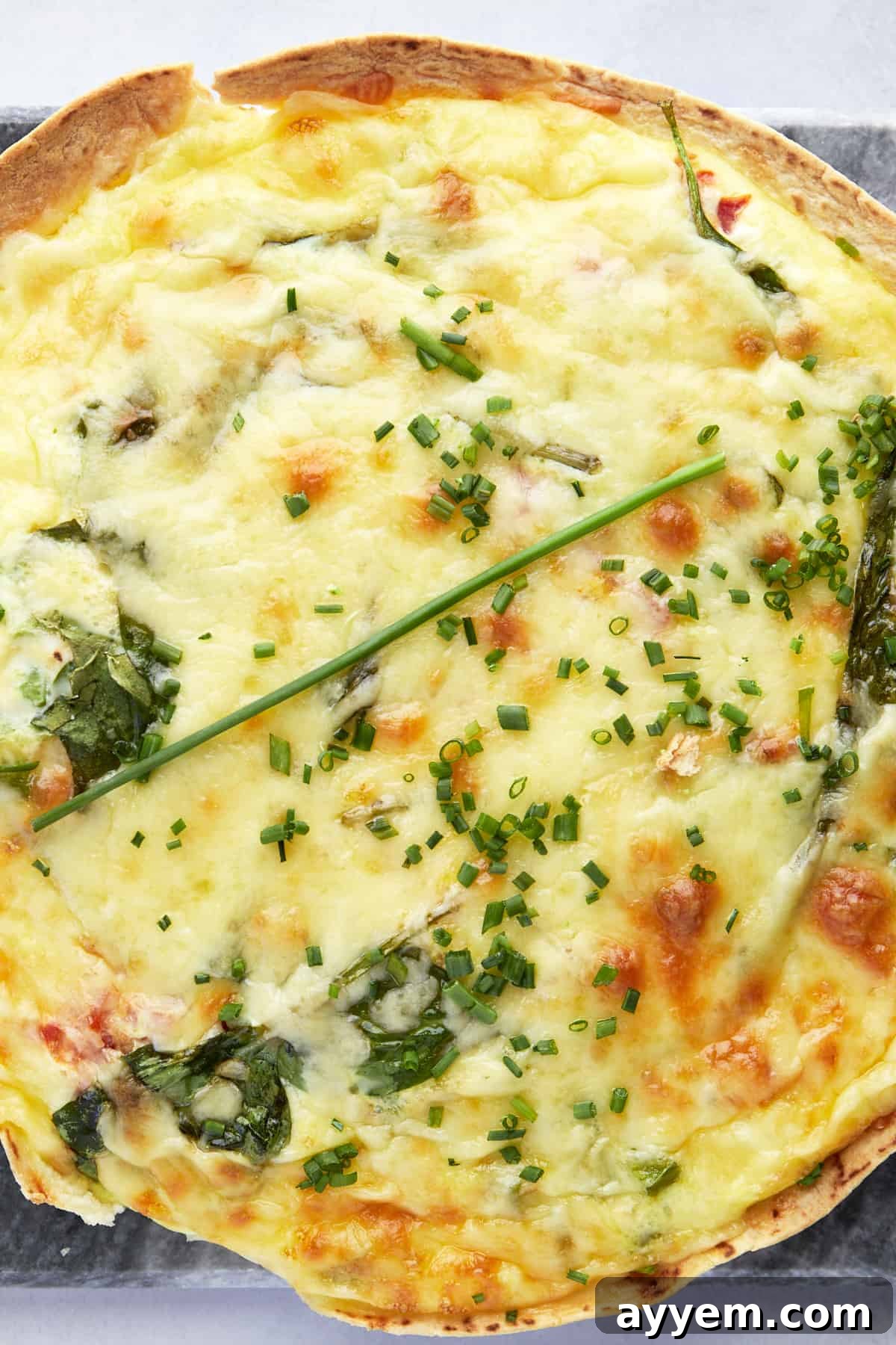 Close up view of an egg tortilla bake topped with fresh herbs. 