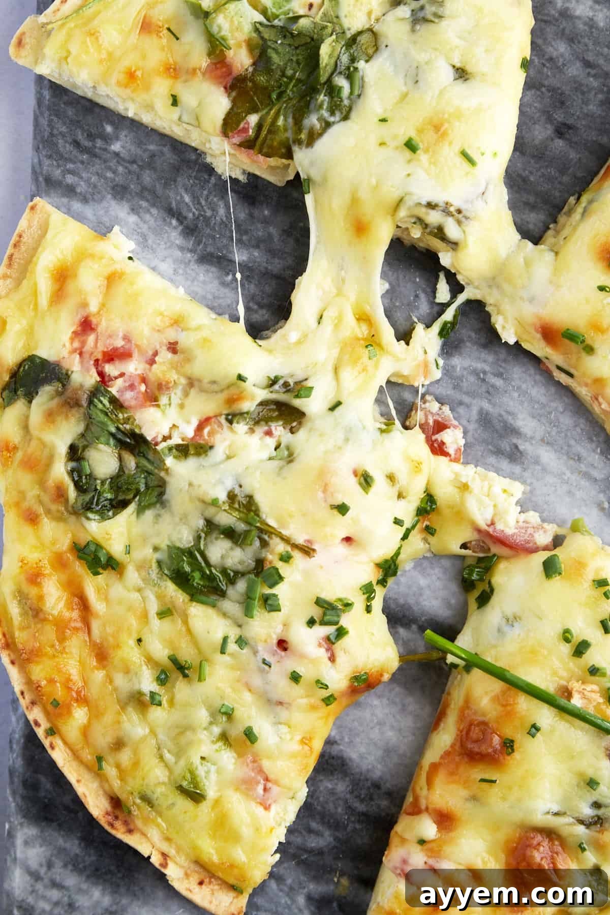 Slices of an egg tortilla bake with cheese and veggies. 