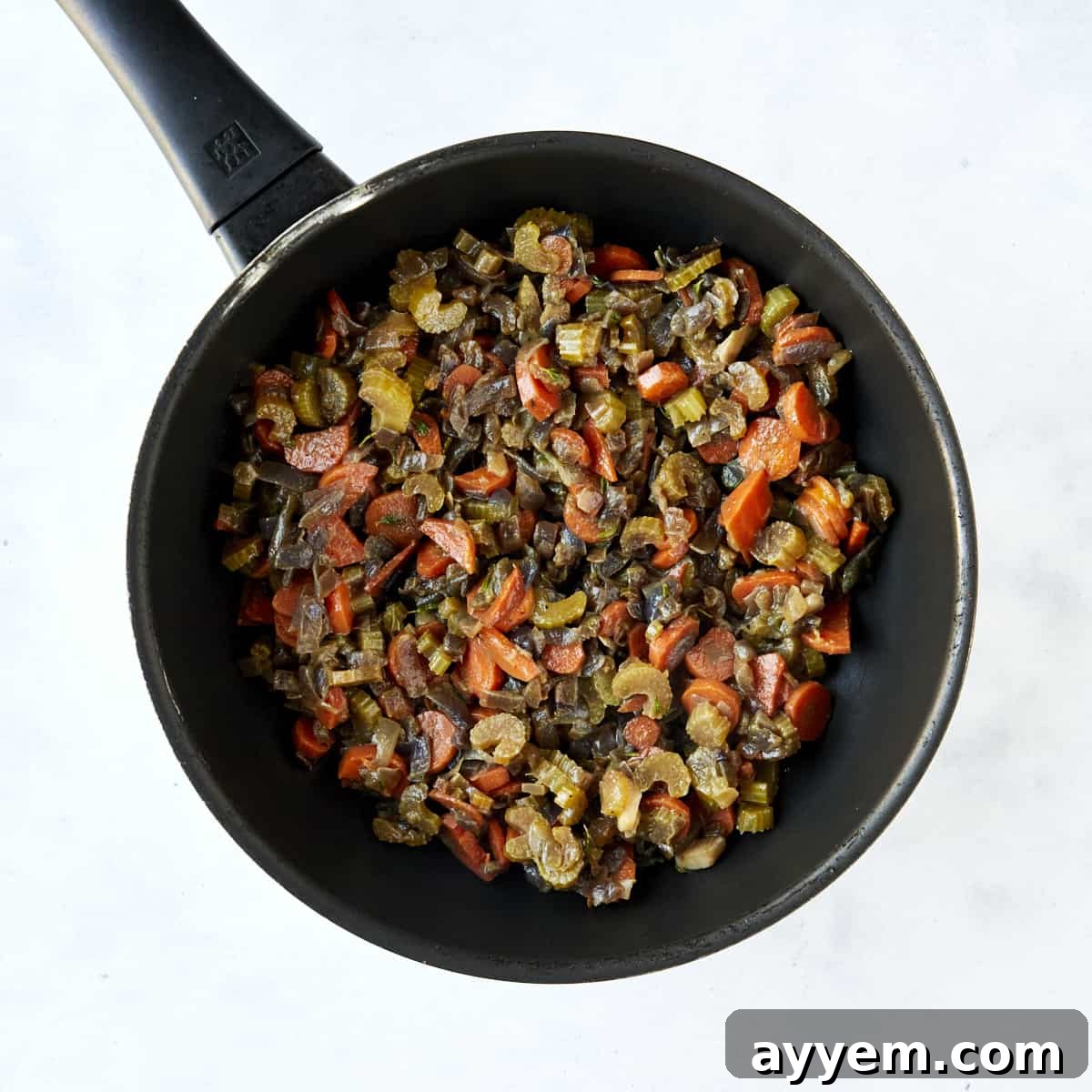 Flavorful Mediterranean Stuffing 4 Sautéed veggies in a skillet and a mixing bowl full of Mediterranean-style dressing ingredients.