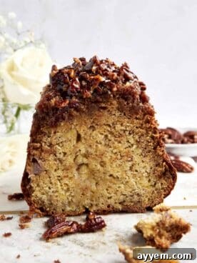 A warm loaf of Pecan Pie Banana Bread, featuring a sweet, crunchy pecan topping.