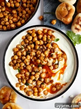 A beautiful bowl of creamy whipped feta dip, generously topped with savory marinated chickpeas.