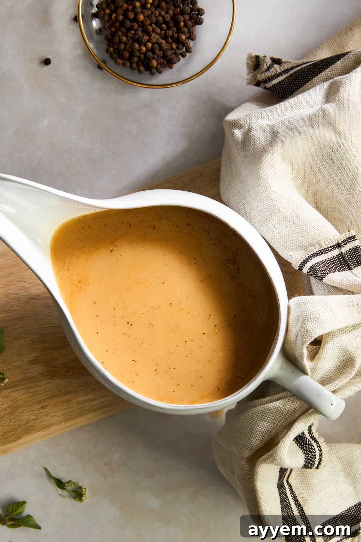 A gravy boat filled with smooth, rich homemade turkey gravy, ready to be served.