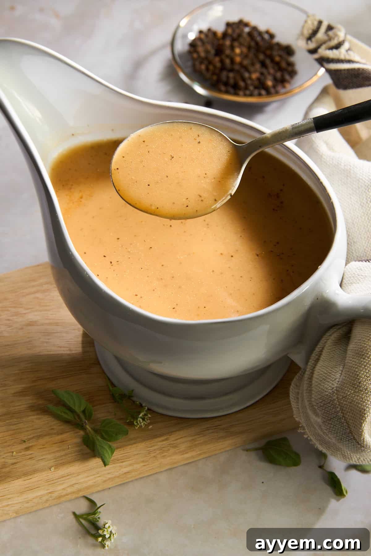 Rich homemade turkey gravy in a white pitcher