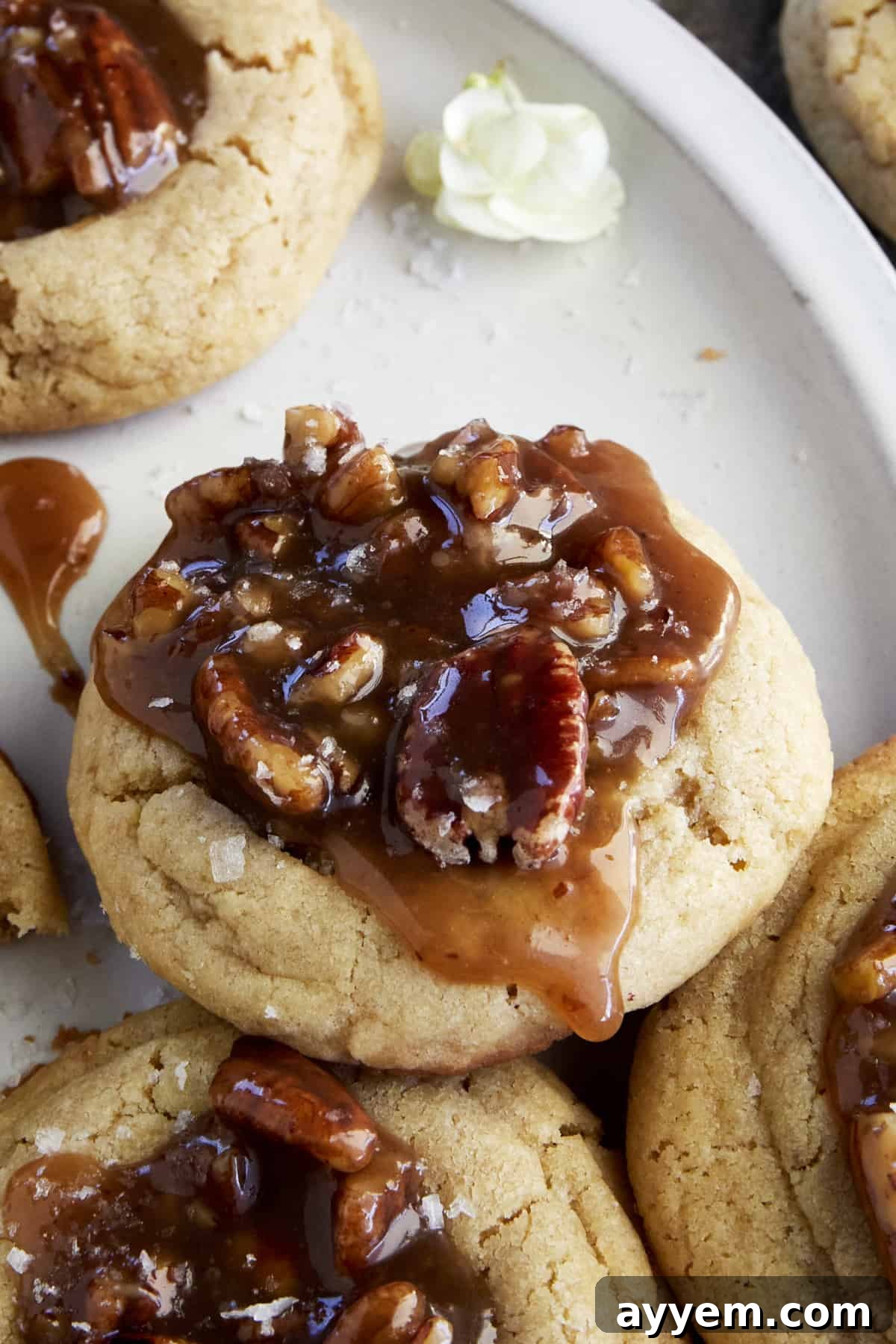 A beautifully arranged plate of Pecan Pie Cookies, showcasing their golden crusts and rich, caramel-pecan centers.