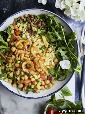 A vibrant Chickpea and Lentil Salad with fresh herbs and a spicy cumin vinaigrette.