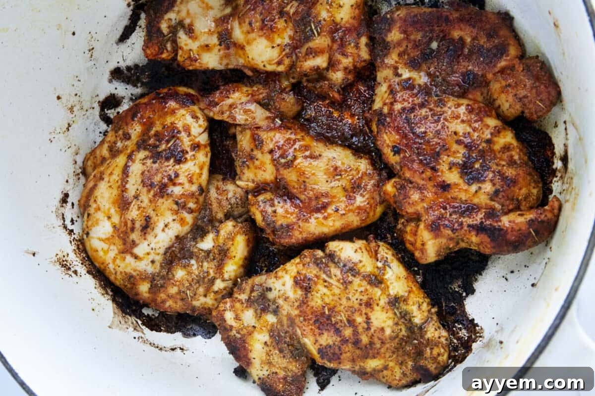 Seasoned chicken breasts seared until golden in a large oven-safe skillet, forming a delicious crust.