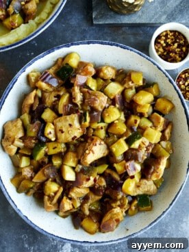A vibrant bowl of chicken and zucchini stir fry, garnished with fresh herbs, showcasing a healthy and quick weeknight meal.