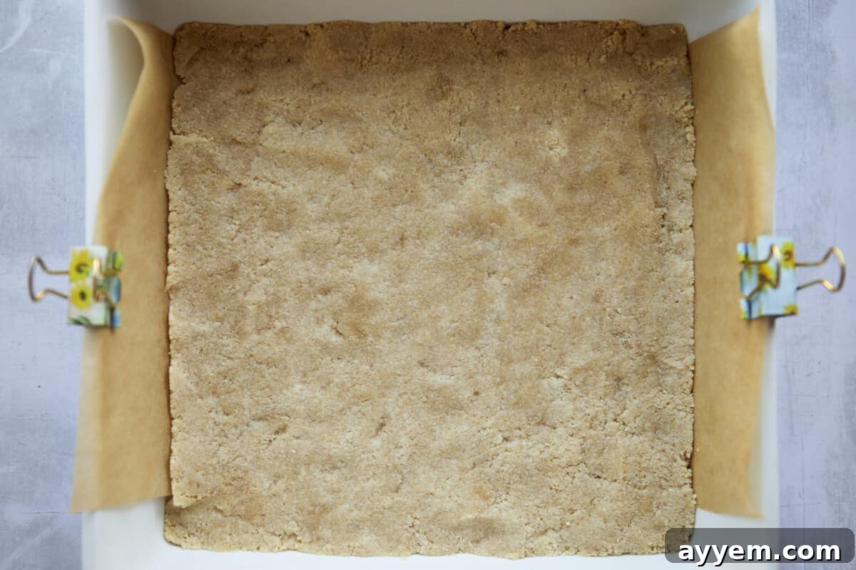 Almond flour crust pressed into a baking dish. 