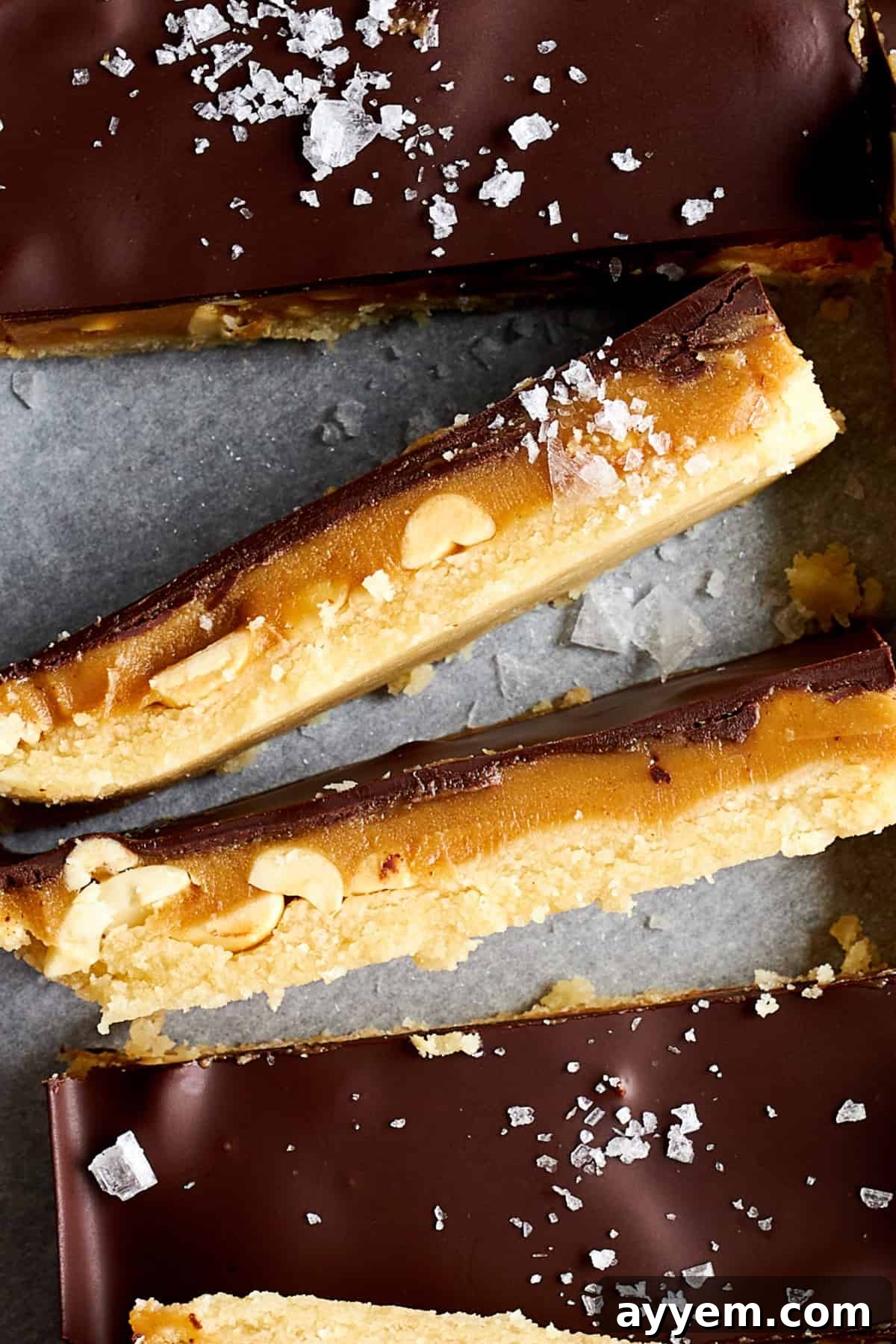Side view of homemade Snickers bars showing the different layers. 