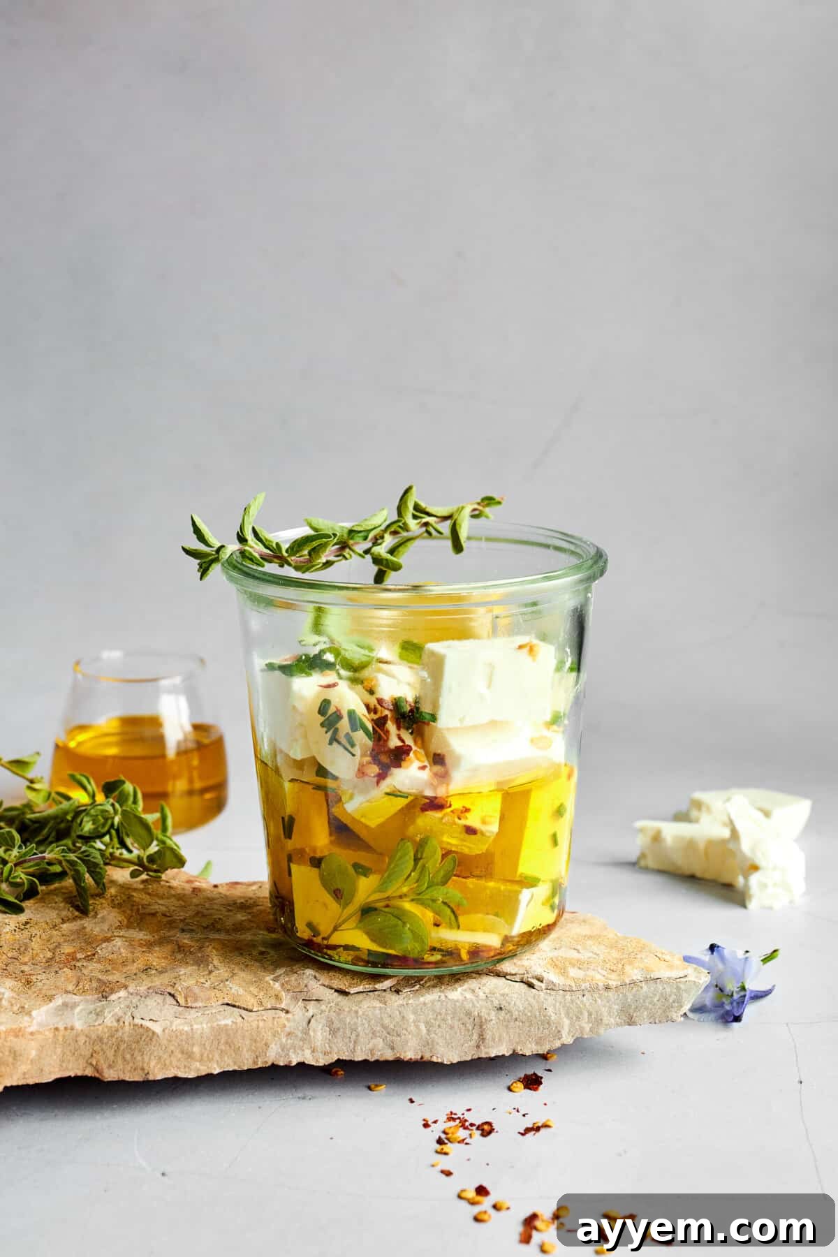 Feta cubes being soaked in an olive oil marinade. 