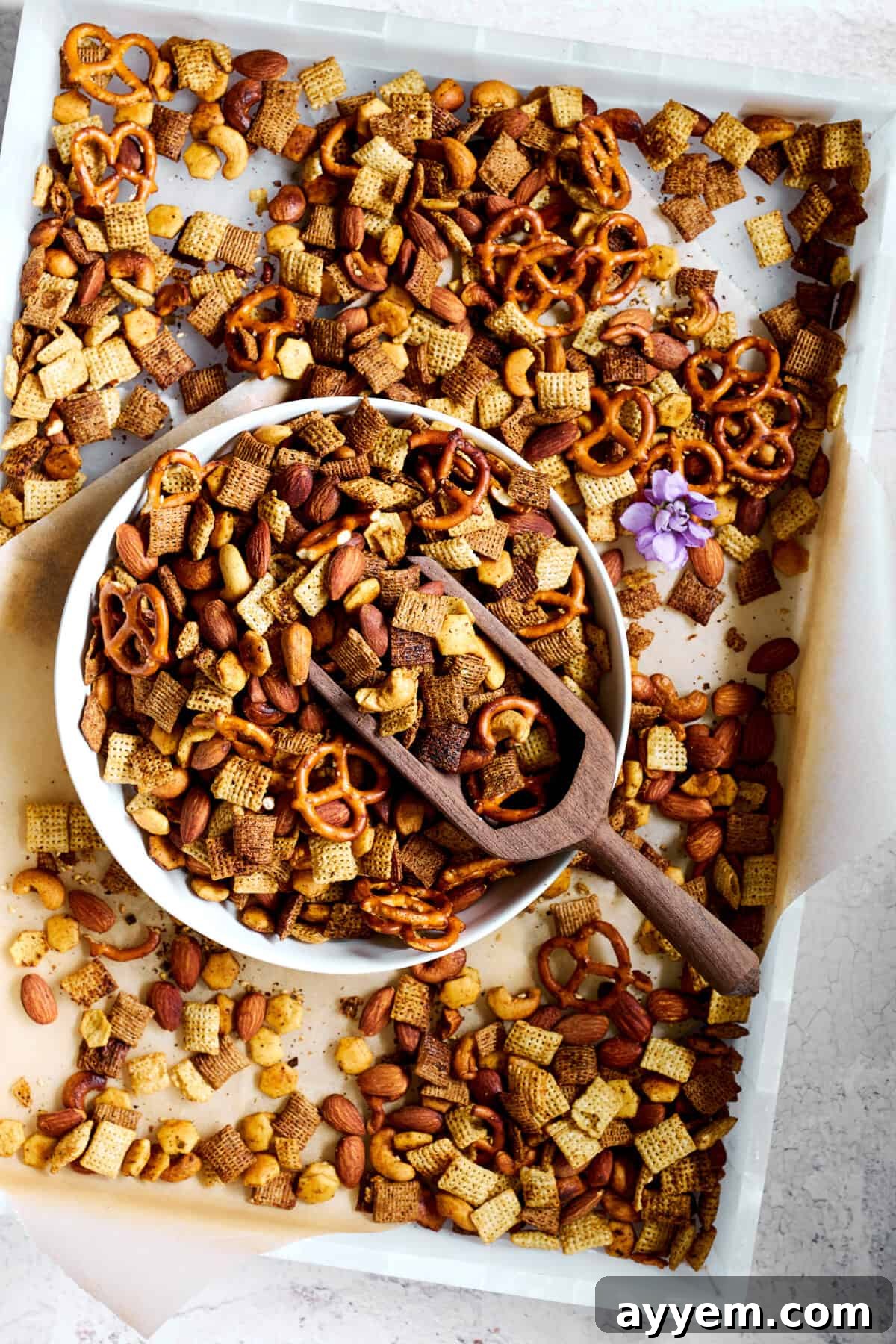 A vibrant bowl of Middle Eastern Spicy Chex Mix on a baking sheet, showcasing its crunchy texture and rich seasoning.