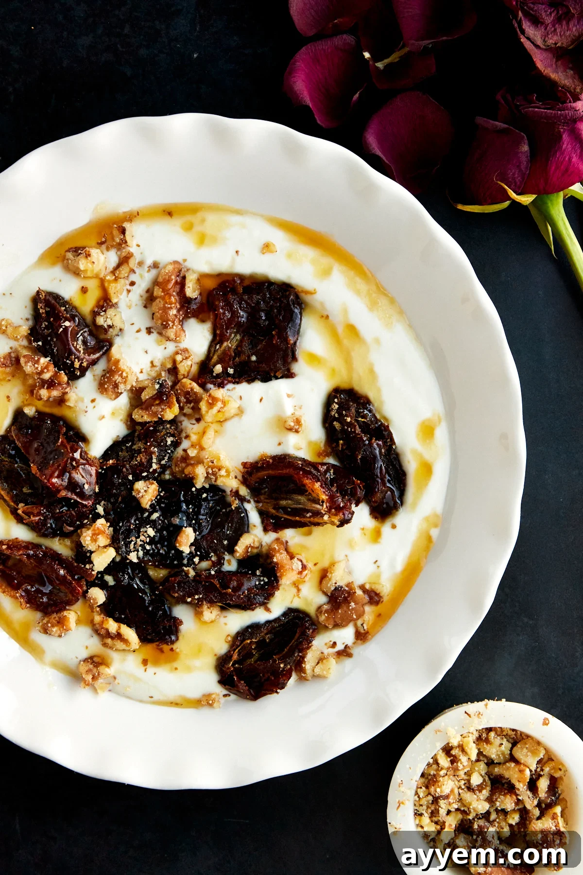 A bowl of honey whipped ricotta and roasted dates.