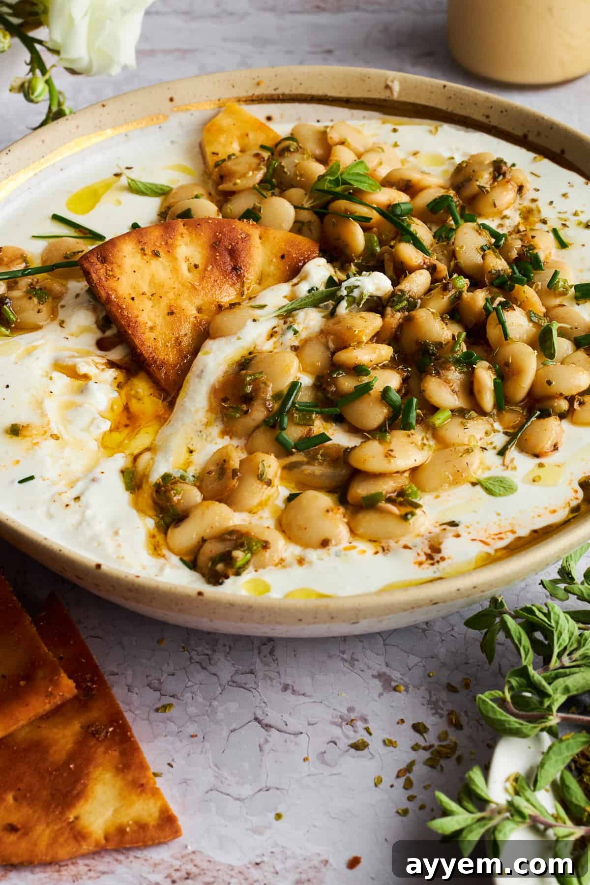 A bowl of marinated butter beans with whipped cottage cheese, ready to be enjoyed as a healthy, protein-rich snack.