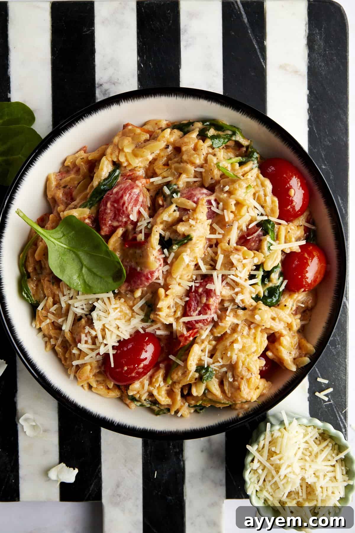 A bowl of Boursin cheese pasta topped with parmesan cheese. 