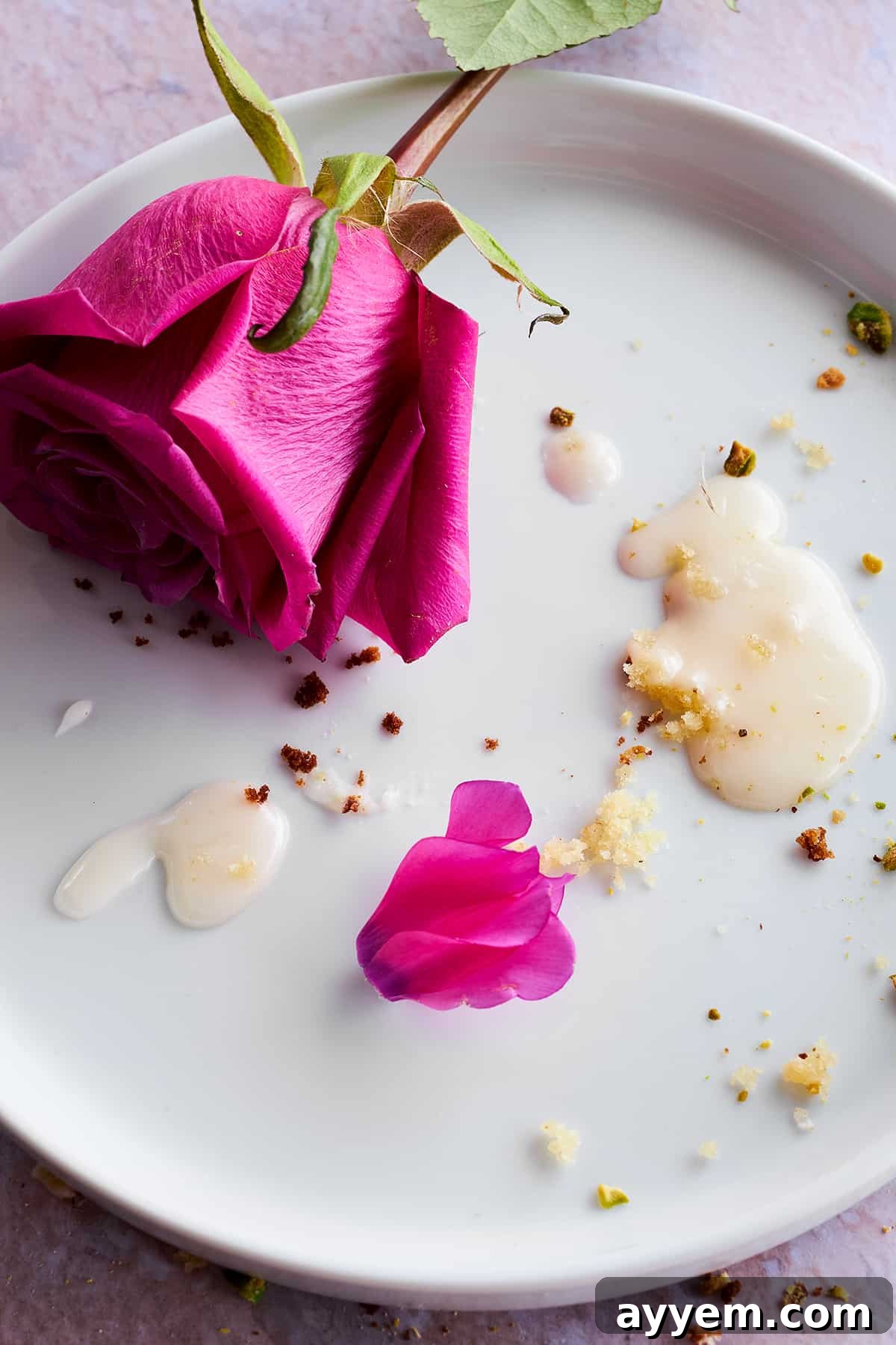 A close-up, low-angle shot emphasizing the height and texture of the Persian love cake, with its colorful toppings clearly visible.