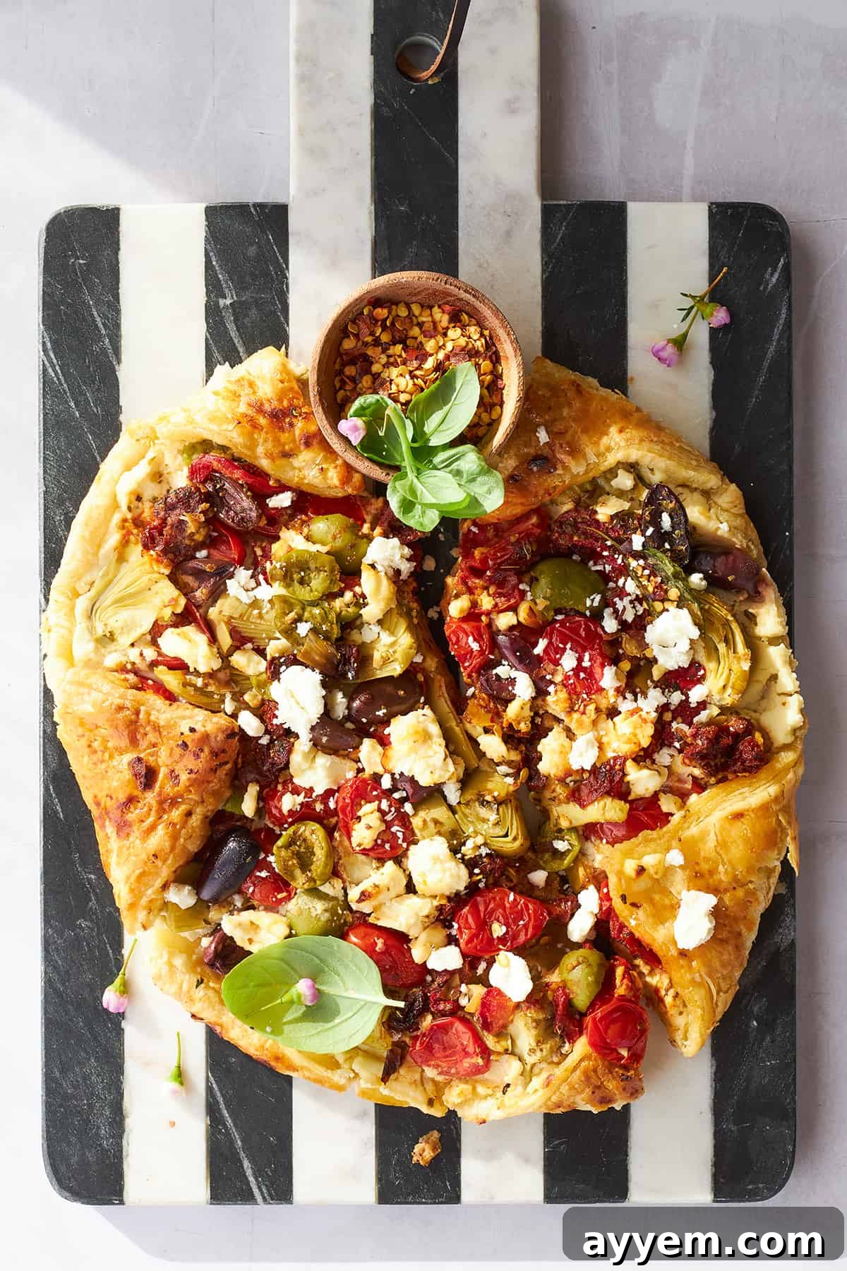 Close-up of a slice of Mediterranean Vegetable Galette, showcasing the vibrant filling and flaky crust.