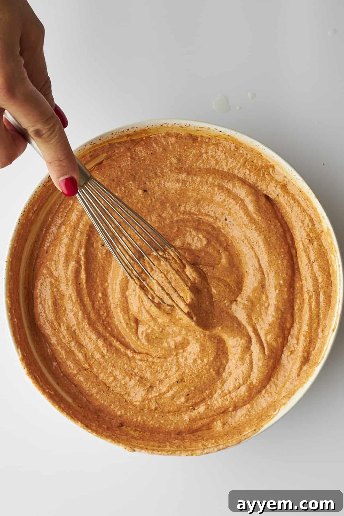 Chicken tikka marinade being whisked. 