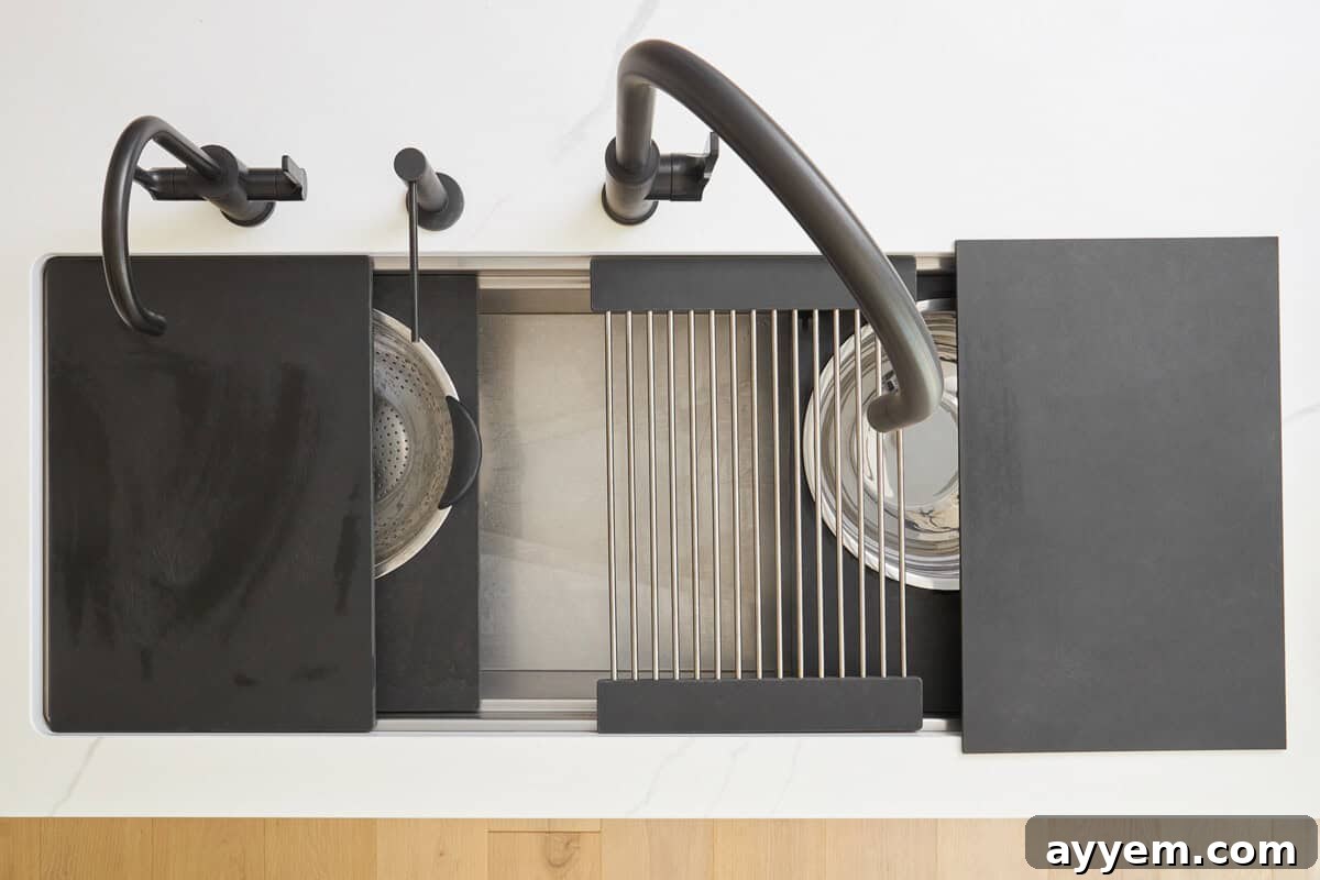 Unlock Your Kitchen's Potential: Workstation Design 3 Overhead image of a kitchen sink with various attachments for cutting boards and wire racks.