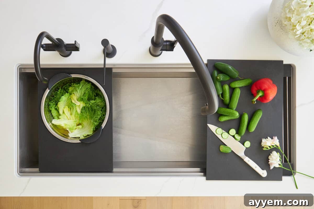 Unlock Your Kitchen's Potential: Workstation Design 5 Overhead image of a clean kitchen sink with a colander attachment and a cutting board attachment.