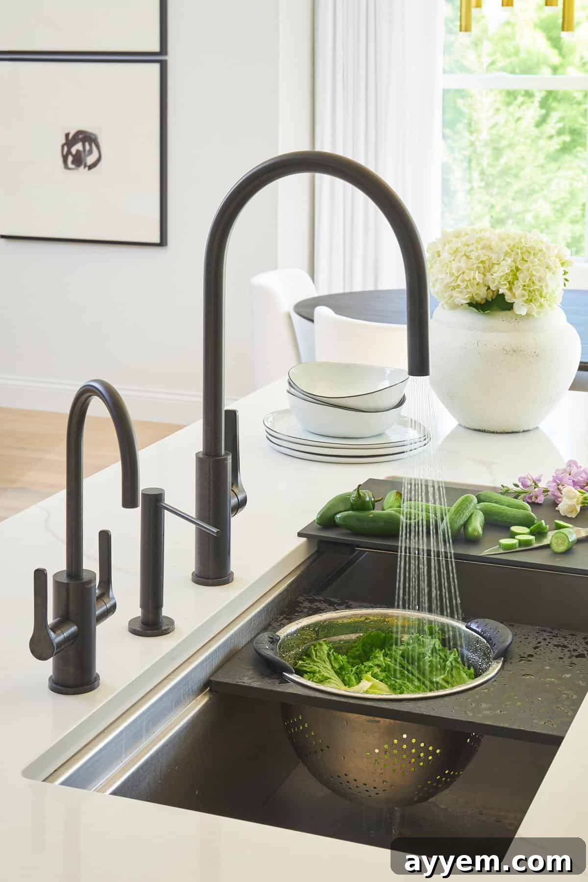Unlock Your Kitchen's Potential: Workstation Design 6 A colander attachment on a sink full of lettuce being rinsed.