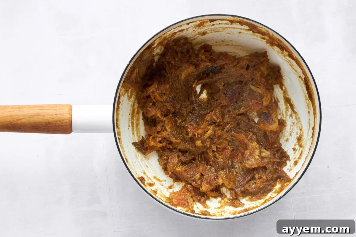 Date paste in a pot, showing its smooth consistency.