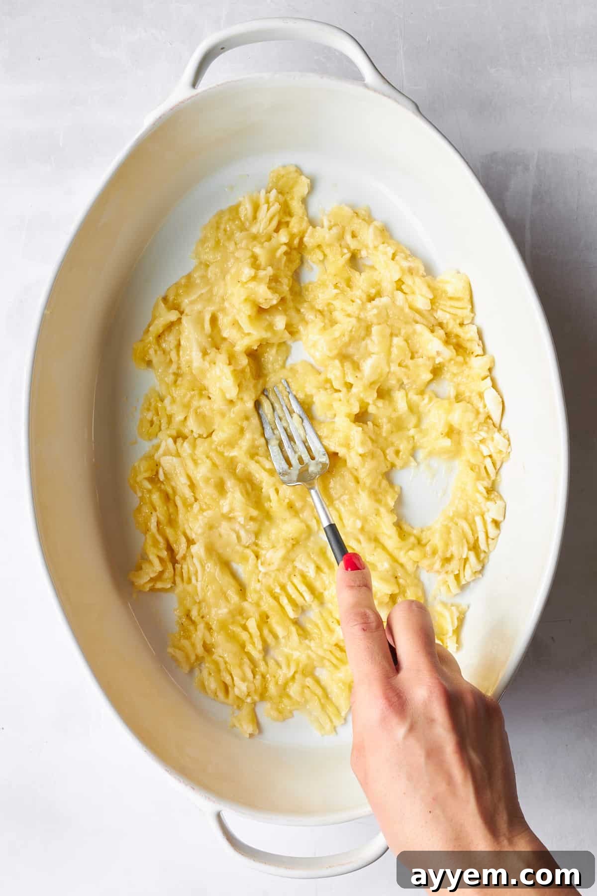 A bowl of fully mashed bananas, ready for mixing.
