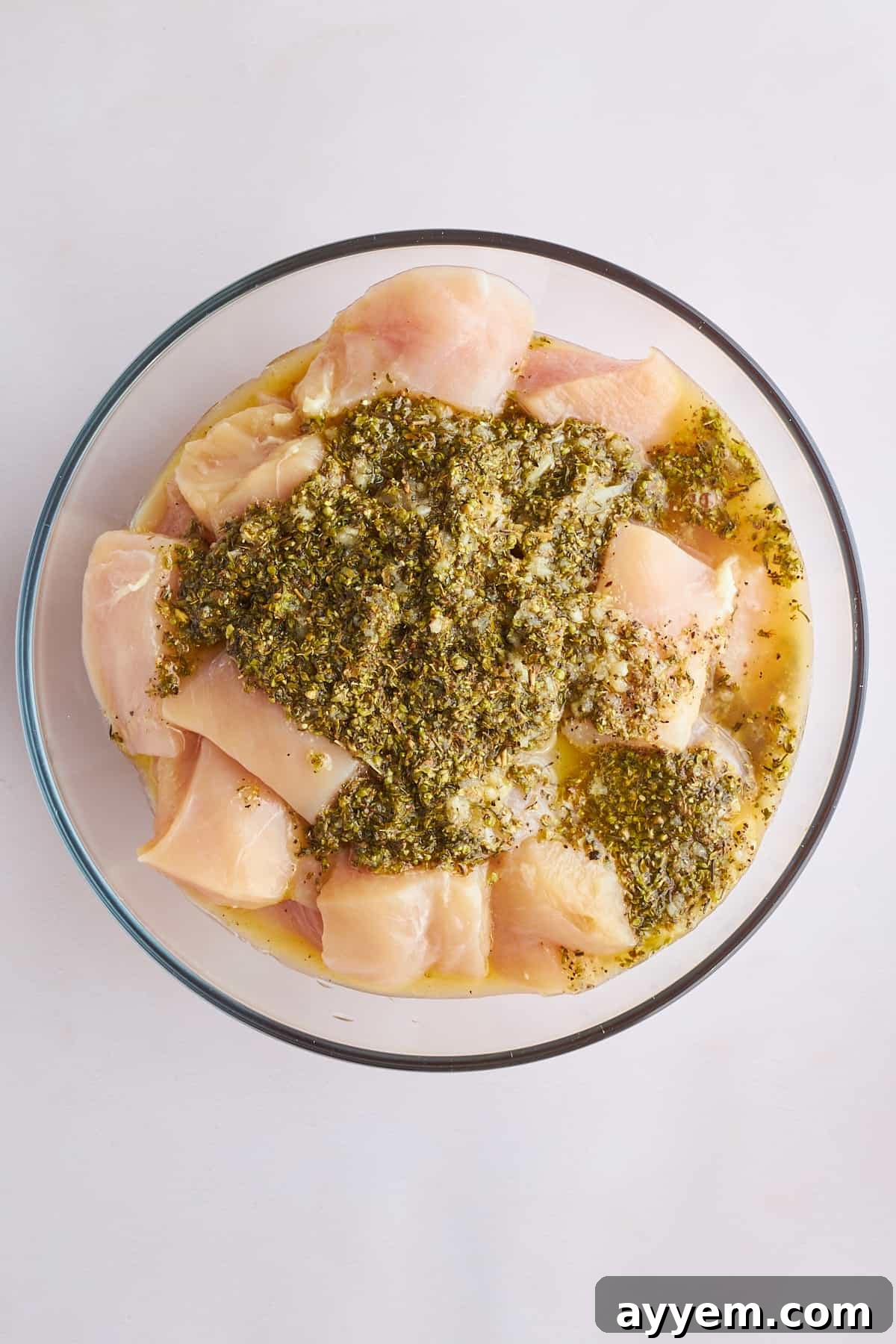 Raw chicken pieces marinading in souvlaki marinade.