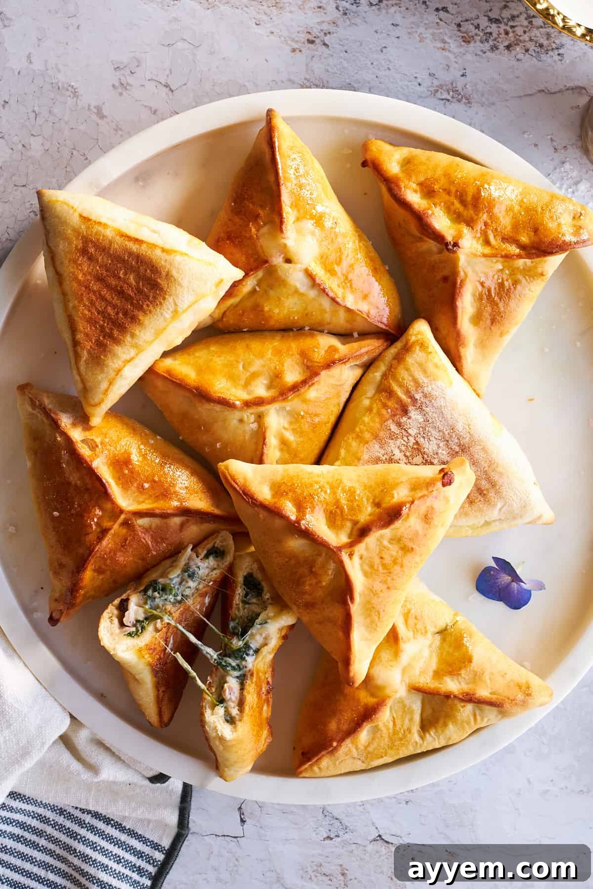 Freshly baked fatayer arranged beautifully on a plate, ready to be served.