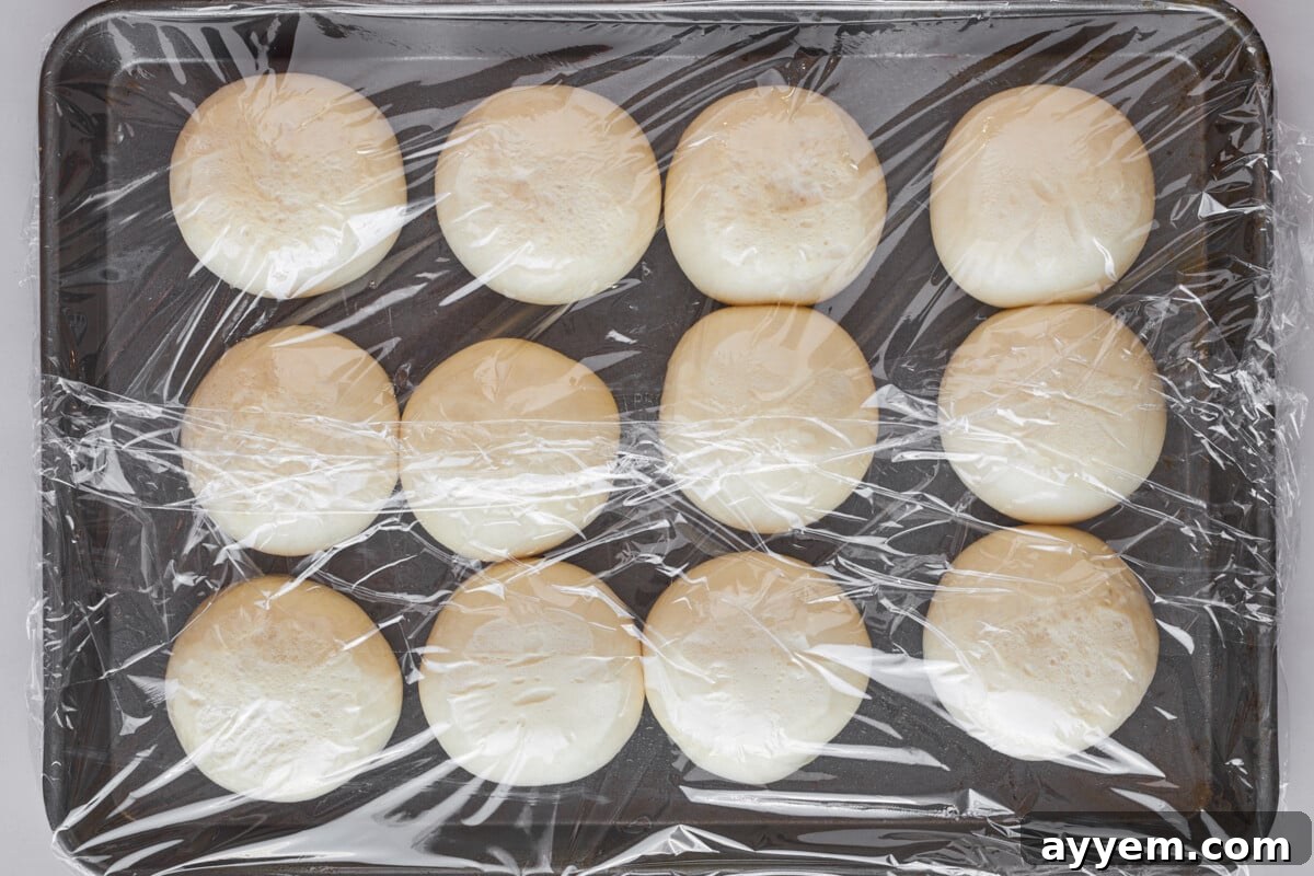 Dinner rolls on a baking sheet being thawed.