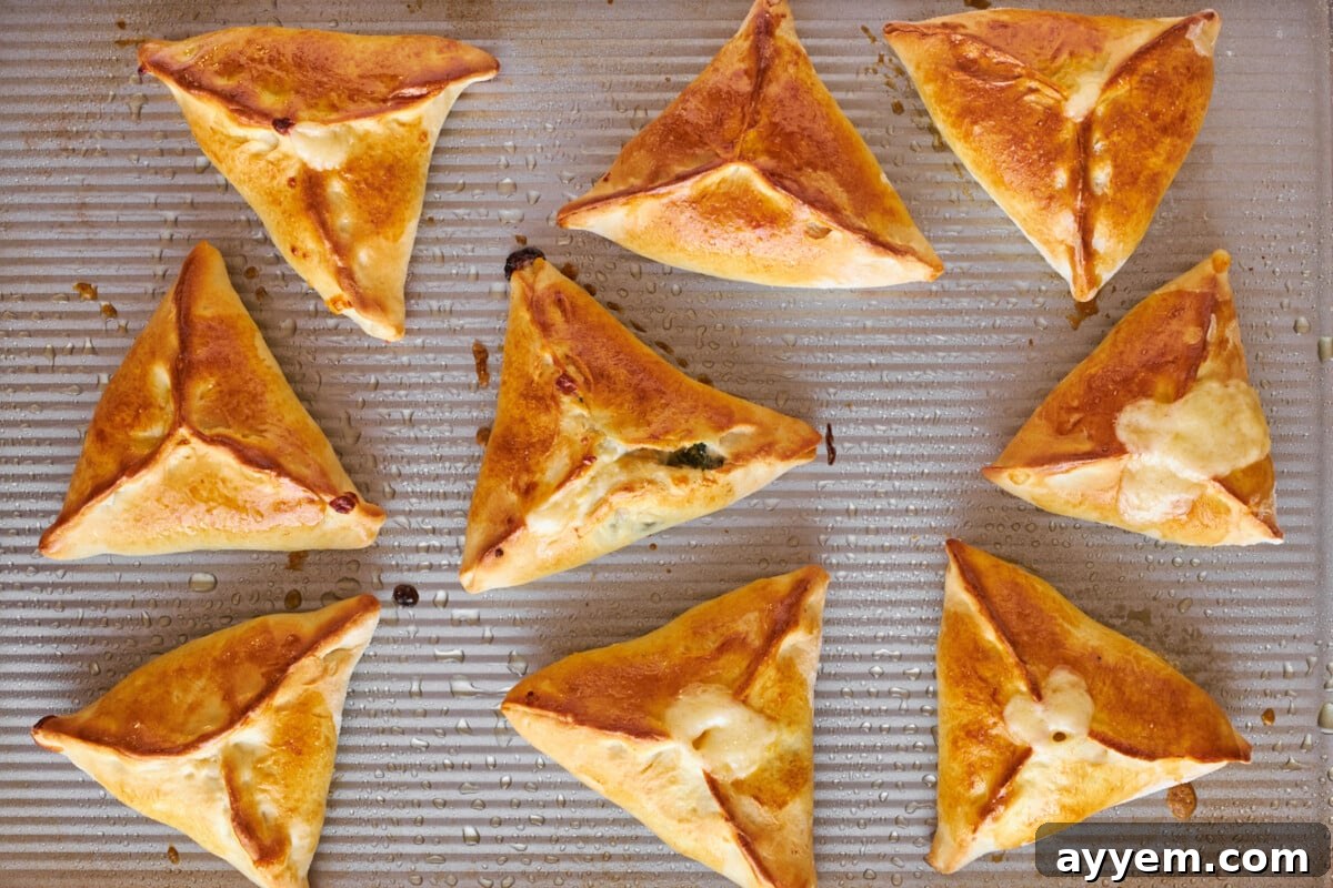 Baked fatayer on a baking sheet.
