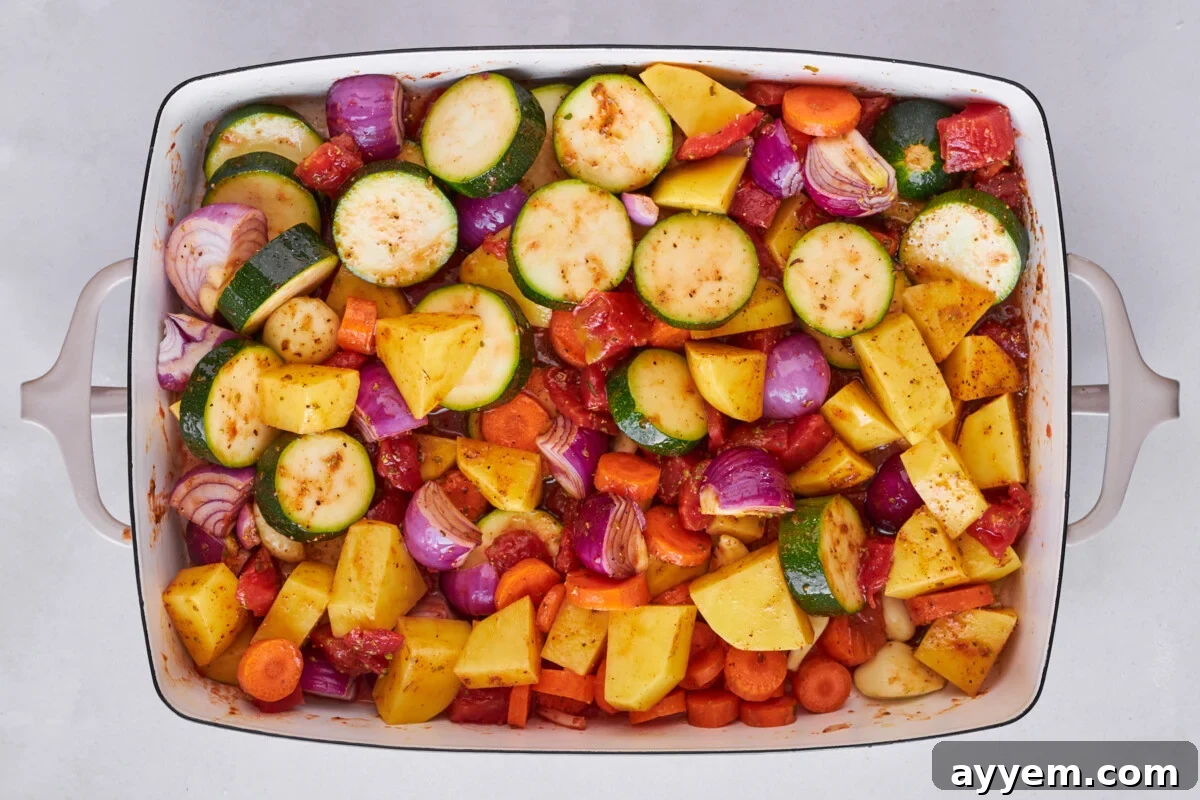 Seasoned vegetables spread in a baking dish.