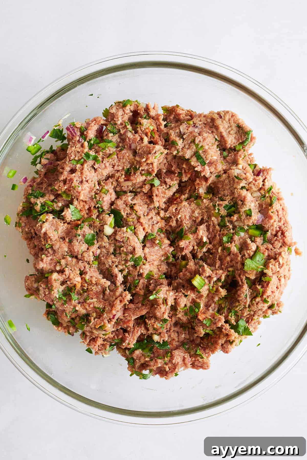 Bowl of raw beef kofta meatball mixture, ready for shaping.