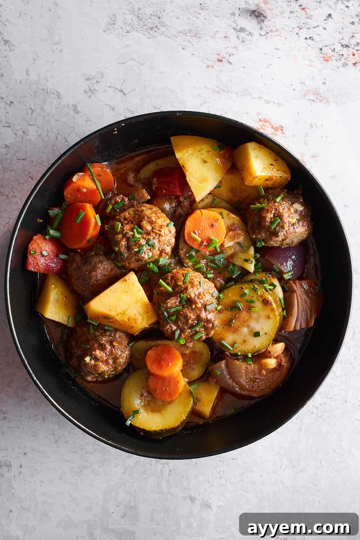 A serving of Beef Kofta Bake in a bowl, showing the tender meatballs and perfectly roasted vegetables, ready to be enjoyed.