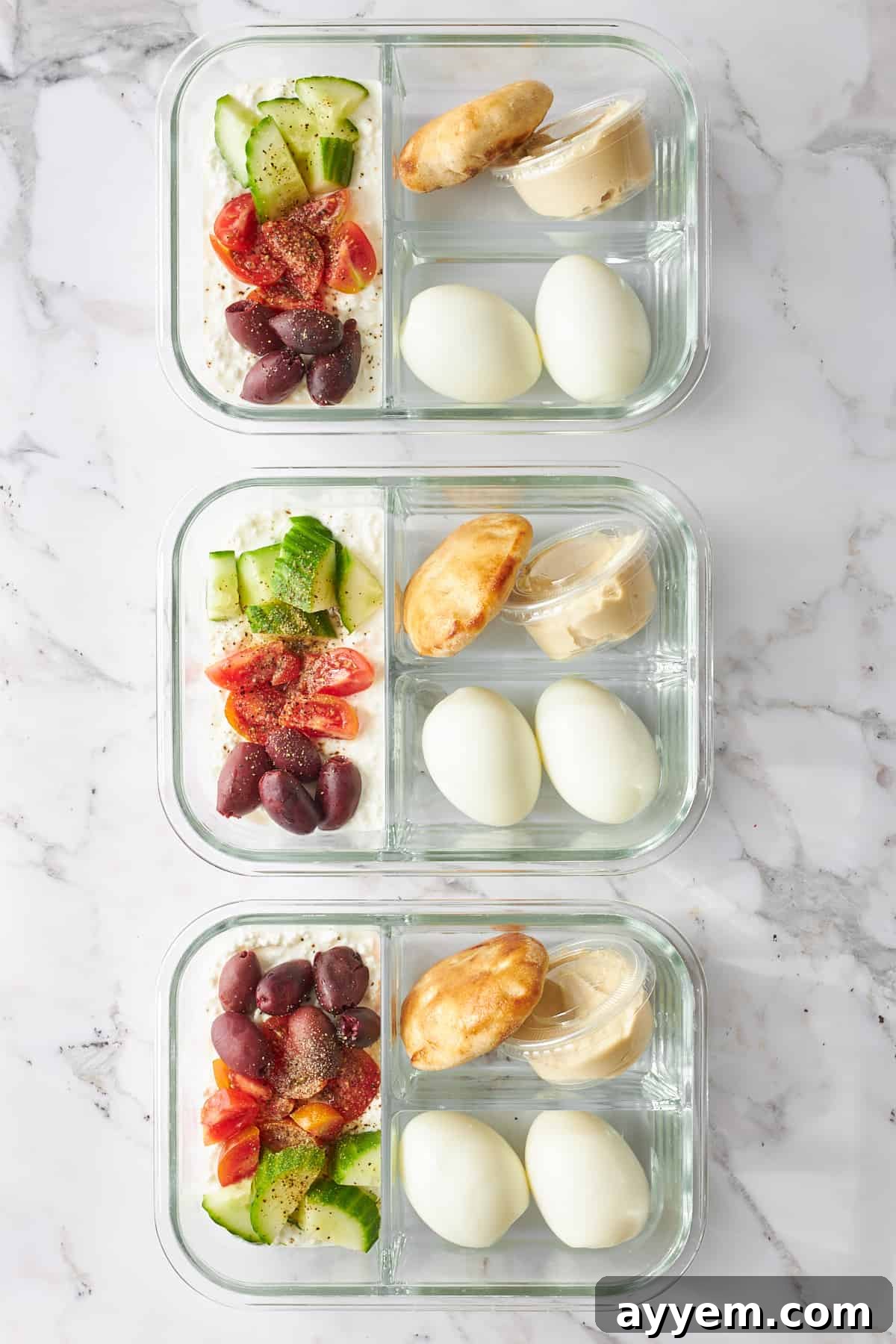 Three containers with vibrant meal prep cottage cheese salad, showcasing its fresh ingredients.