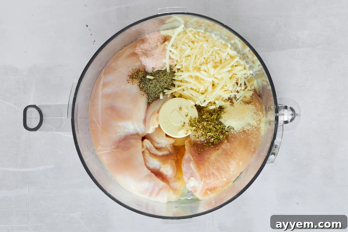 Chicken pizza crust ingredients in a food processor.