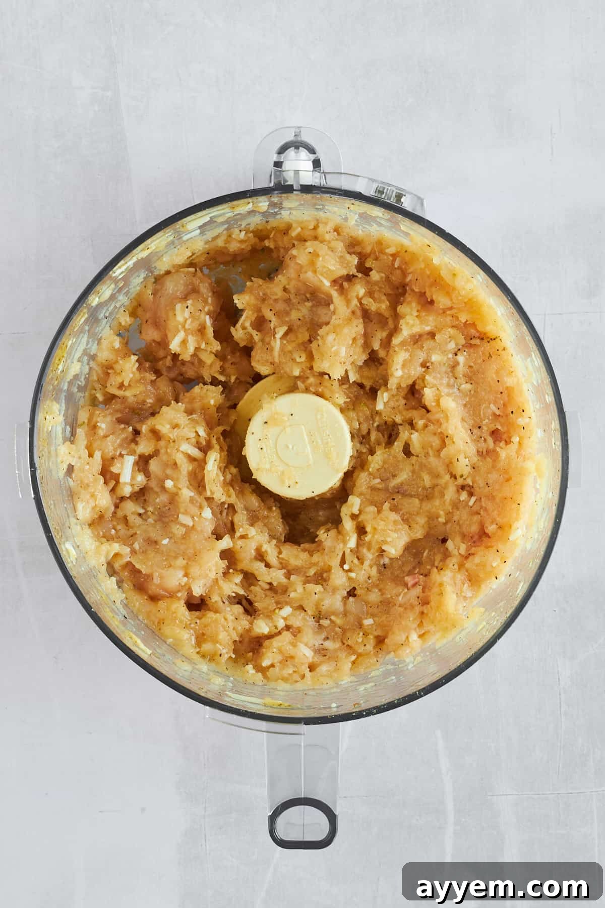 Crispy Chicken Crust Pizza 4 Raw blended chicken crust in a food processor, showing the smooth, pasty consistency.