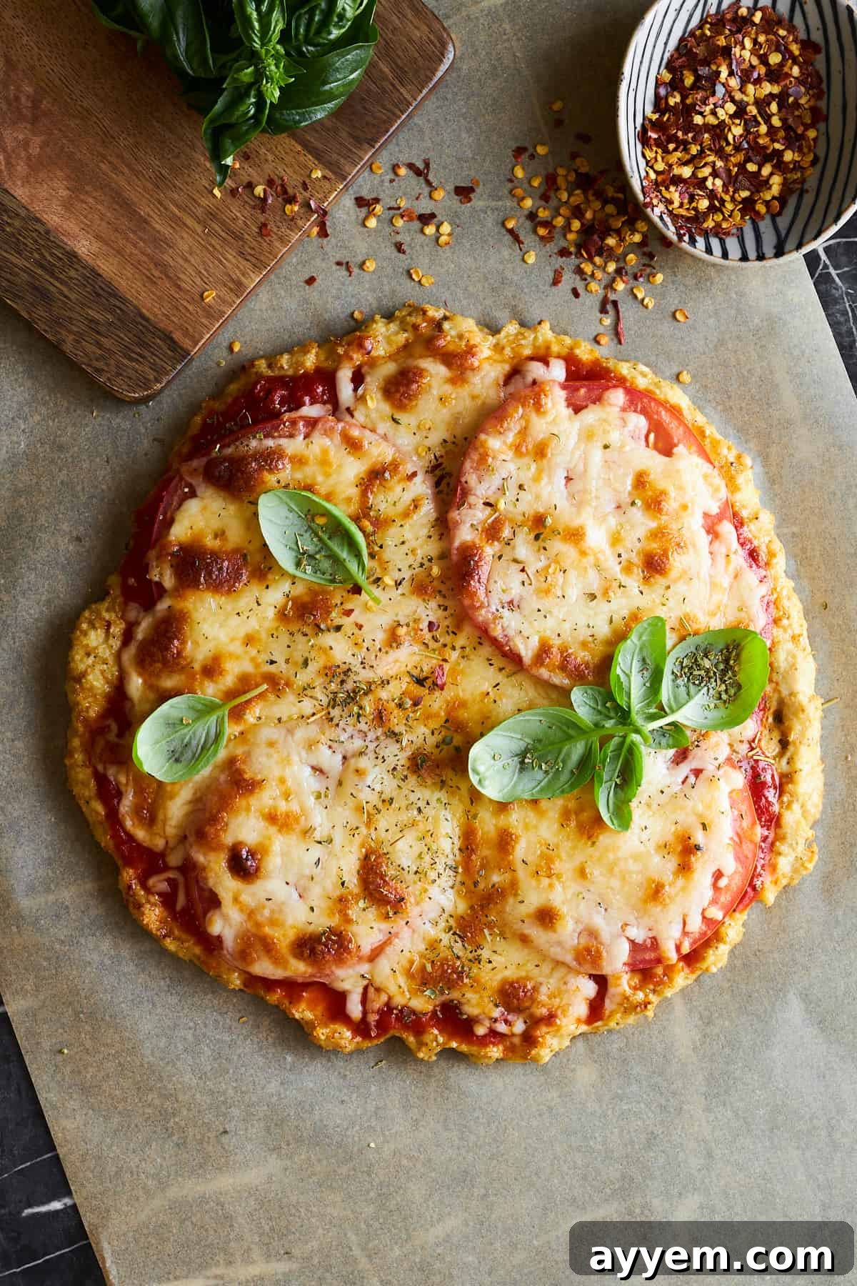 Crispy Chicken Crust Pizza 10 Chicken crust pizza topped with oregano and basil, ready to be served.