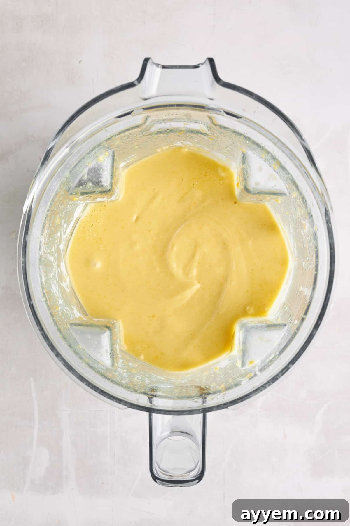 Lemon bread batter being blended in a high-speed blender.