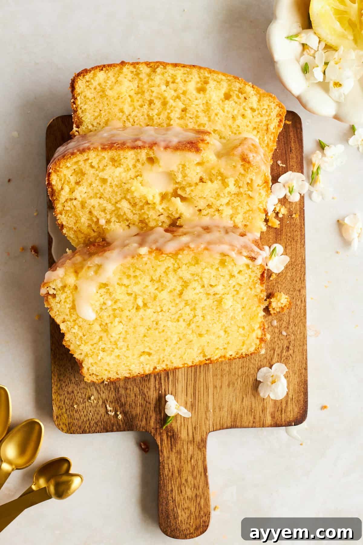 Three slices of perfectly glazed lemon bread, ready to be served.