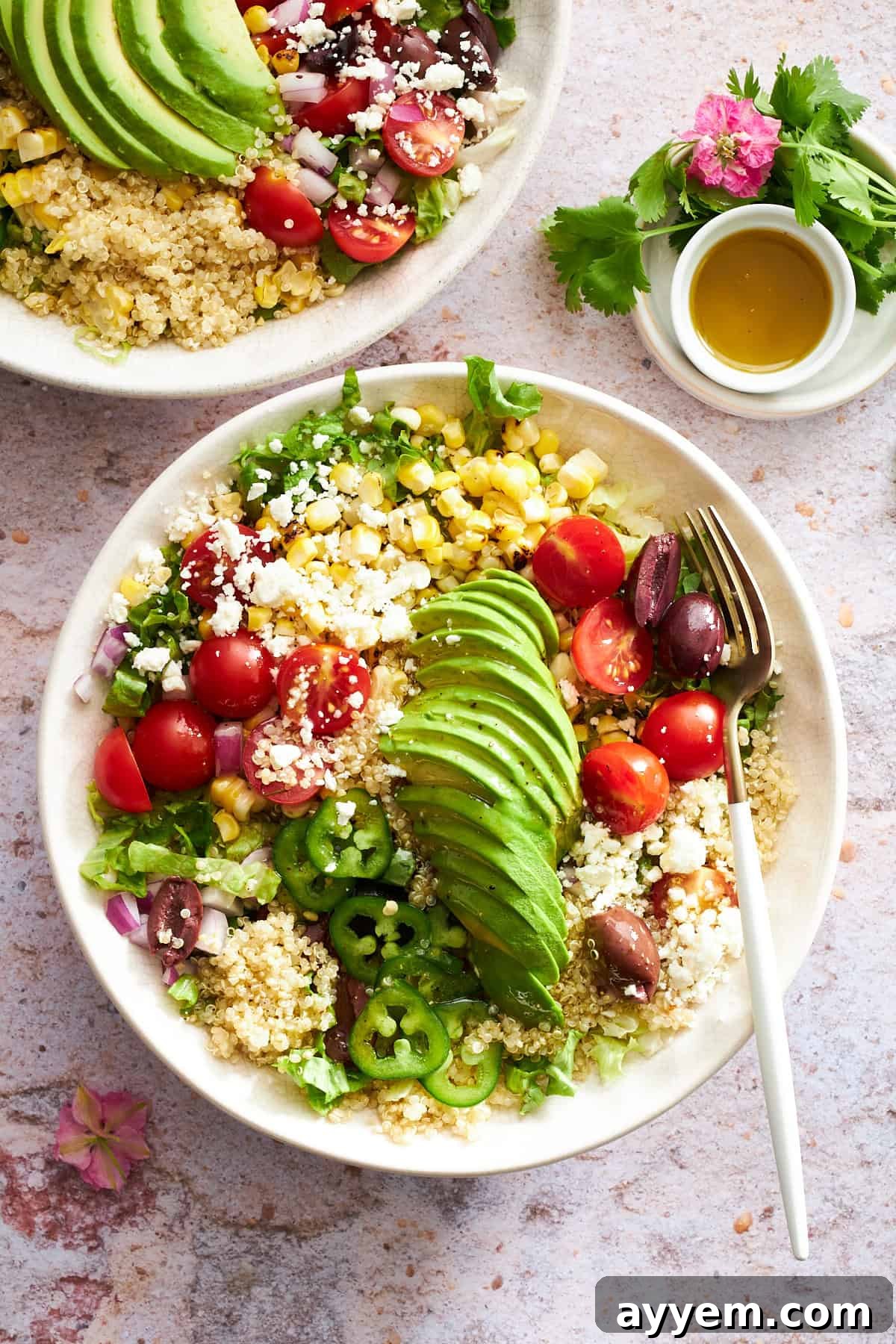 A vibrant Mexican Quinoa Salad in a serving bowl, showcasing colorful ingredients like corn, tomatoes, avocado, and cilantro.