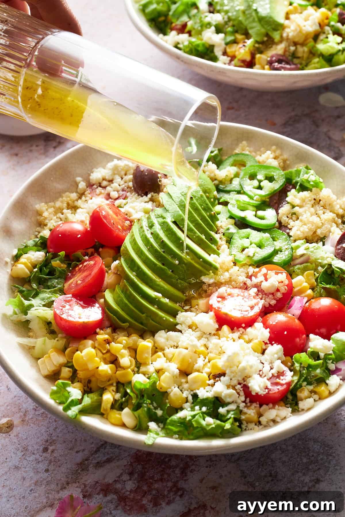 Close-up of Mexican Quinoa Salad, highlighting the textures of quinoa, corn, and avocado cubes.