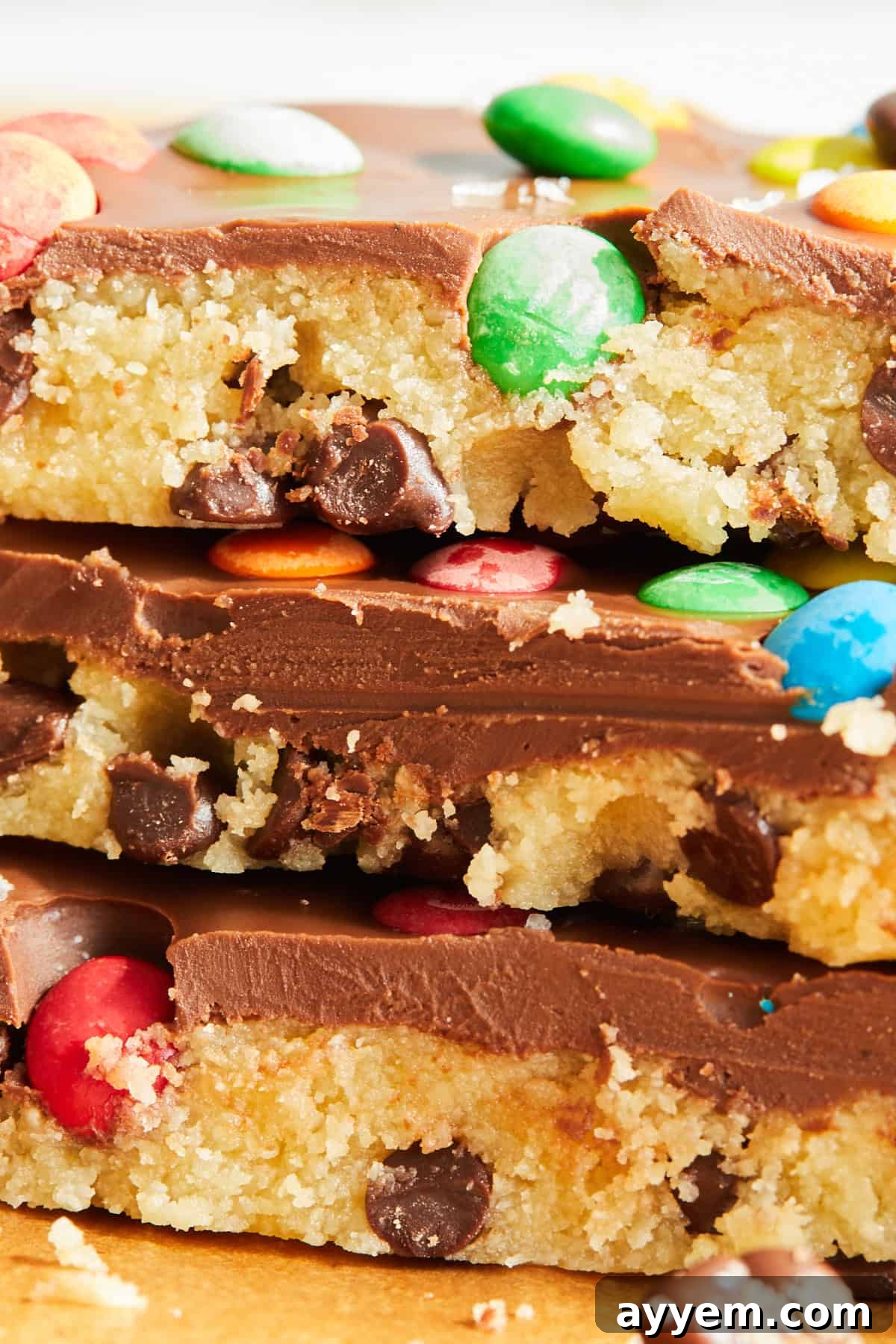 Multiple pieces of chocolate chip cookie dough bark are neatly stacked, highlighting their tempting layers.