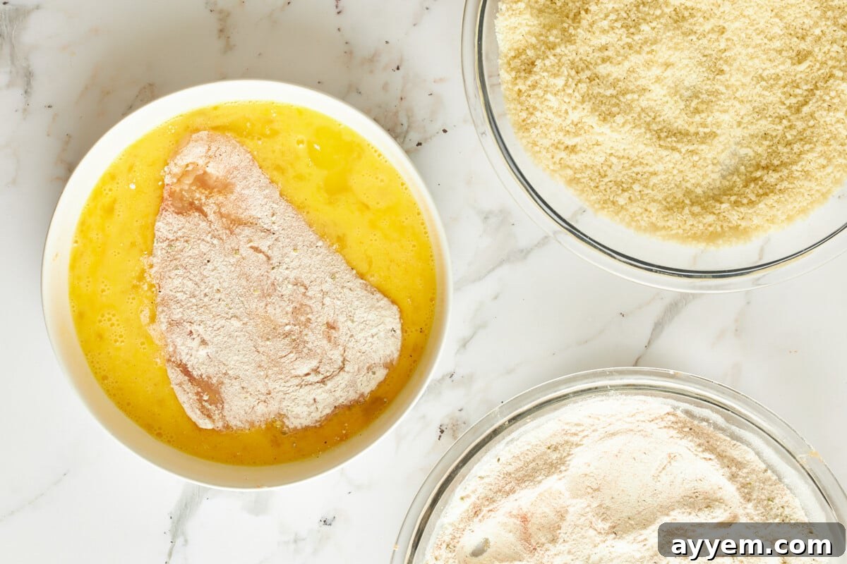 Floured chicken in egg wash.